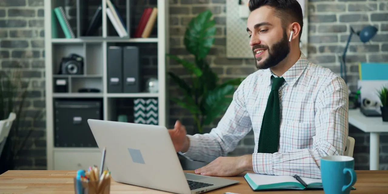 A senior professional reviewing career documents at a desk by a window